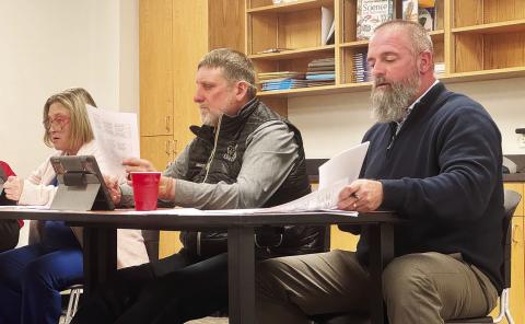 AISD Superintendent Zach Morris and trustees Jennifer Hodges and Ray Bradley review SB 11, which resolves the district to adopt a period of daily prayer, which officials say is unnecessary since the district already supports the expression of faith. JEFF HURT