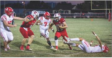 Roby Sophomore Rhylon Lester fights through Longhorn defenders during the Lions' 0-27 loss to Loop last Thursday night. PHOTO BY MARK MARTINEZ