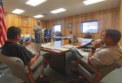 Aspermont City Council Members, Matt Fraser and Chris Lipham consider Danny Barrett with TCG's proposal for mitigating dilapidating structures along Aspermont's main corridor.