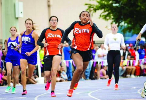 Rotan's Belle Turner recieves the hand off from teammate Braylee Carrillo in the girl's sprint relay. The Lady Hammer sprint relay team of Avery Gonzalez, Braylee Carrillo, Belle Turner, Talyn Lewis, &amp; alternate Kate Van Poppel, qualified as a wildcard entry for the State Meet after achieving the fastest 3rd place time in all four Regions. Photo by: Mark Martinez