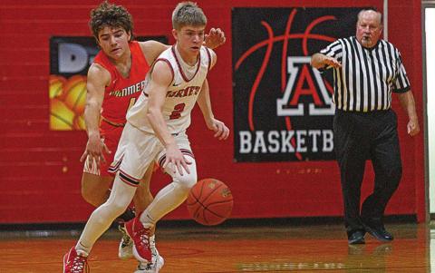 Hornet Keltyn VanMeter slips by Rotan's Zac Flores during last Friday's win over the Hammers. Photo by: Mark Martinez