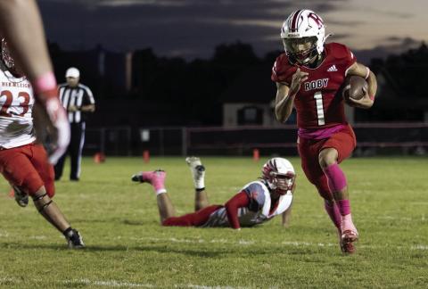 Roby's Keegan Encizo slips Cardinal defenders en route to the endzone during the Lions' 6-52 loss to Hermleigh last Friday. Encizo would record only score of the night for Roby. Photo by Mark Martinez