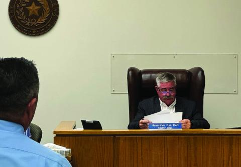 Director of court collections with Nolan and Mitchell counties, Bridger Anglin proposes ways to utilize his services as Fisher County Judge Ken Holt reviews the county budget ahead of this month's certified valuations.