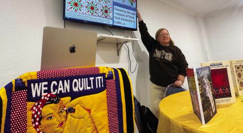 During her presentation, Ellen Goodwin points to a Civil War-era quilt made by Susan Robb for her stepson, William Henry Robb, who served in the Confederate Army. The quilt is now housed at the quilt museum at Texas Tech University. PHOTO BY JEFF HURT