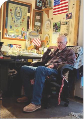 Vietnam veteran Sgt. Leonard Haag reflects at his desk in his Stonewall County home. His medals line the wall, but what he treasures most are the photos and handmade gifts from his grandchildren.