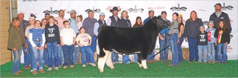 Fisher County 4-H exhibitor Kinley Barnett, joined by family and friends, proudly presents her show steer, which earned the title of Medium Weight Reserve Champion European Crossbred Steer at the Fort Worth Stock Show &amp; Rodeo, Photo Courtesy of FWSSR