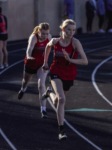 Aspermont's Ashlyn Holson recieving the handoff from teammate Matti Polk in the 4x200m relay. (PHOTO BY MARK MARTINEZ)