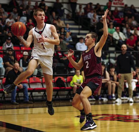 Roby senior Dallas Shumaker looks for an open man before jumping out of bounds. Photo by: Mark Martinez