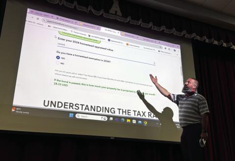 AISD Superintendent Zach Morris walks attendees at Monday’s town hall meeting through the tax calculator available on the website for voters to learn more information about the district’s $7.5 million bond proposal.