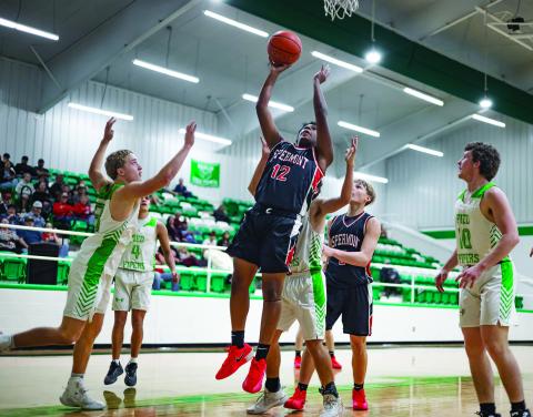 Aspermont's Isaiah Johnson puts up the game tying layup to force an overtime between the Hornets &amp; Pipers. P hoto by: Mark Martinez