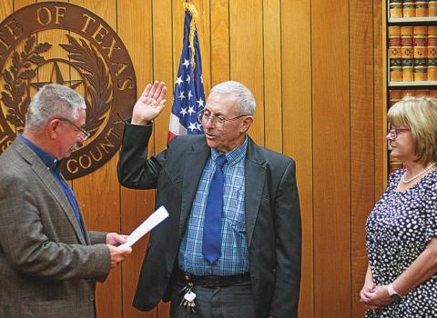 Teressa Ford looks on as Judge Ken Holt swears in her husband, Randy Ford, as the new Fisher County Sheriff Monday afternoon.