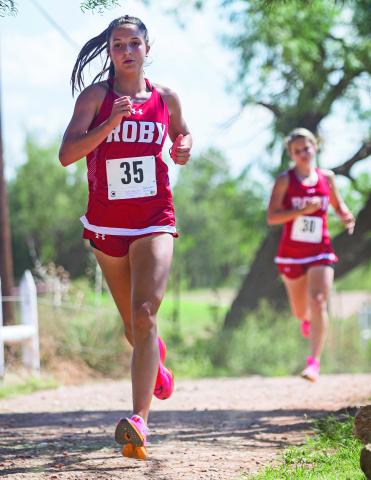 At the District XC meet in Rotan earlier last month, Lady Lion senior runner Hailee Garmer leads the pack followed close behind by fellow senior teammate Chasity Benson. Benson would eventually overtake Garmer to place 1st overall, while Garmer finished 3rd. At the Regional meet in San Angelo, Garmer would turn the tables and take 1st place overall, with Benson finishing 2nd. The team once again would clinch the Regional Championship and punch their ticket back to State. PHOTO BY MARK MARTINEZ