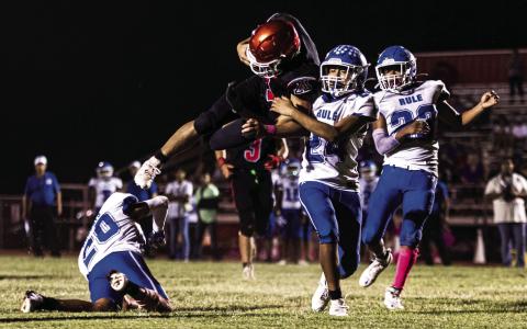 Top: Aspermont's Caleb Broshears brushes off Bobcat defenders to gain a first down during the Hornets 66-22 win over Rule last Friday night. The Hornets kick off district play 1-0 and will next face Lueders-Avoca in Lueders this Thursday night at 7pm PHOTO BY: MARK MARTINEZ
