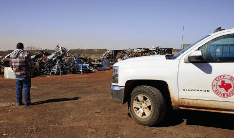 Aspermont City Manager Lorenzo Calamaco looks out over two, 40-yard containers worth of scrap metal that was recently declined for salvage after testing positive for radiation. (PHOTO BY TRICIA HURT)