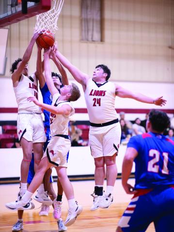 Left: Roby senior Chasity Benson puts up a shot of over a Houndette defender during the Lady Lions' 50-9 routing of Knox City Tuesday night. The Lady Lions are one step closer to a district championship pending a potential win against the Aspermont Lady Hornets this Friday in Aspermont. PHOTO BY: TRICIA HURT