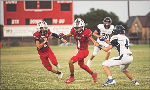 Sophomore Lion Gage Barrera takes the ball upfield covered by Senior Lion Keegan Encizo during Roby's 20-56 loss to Lubbock Kingdom Prep Academy last Friday night at home. The Lions will take the field again this Friday night at home against Irion County for Homecoming. Photo by Tricia Hurt