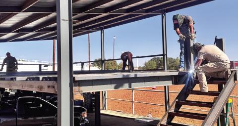 Workers construct the steel frame for a new seating area at the Fisher County rodeo grounds ahead of the 82nd annual Fisher County Fair and Rodeo. The two-level structure is part of several improvements underway at the grounds as organizers prepare for this year’s event.
