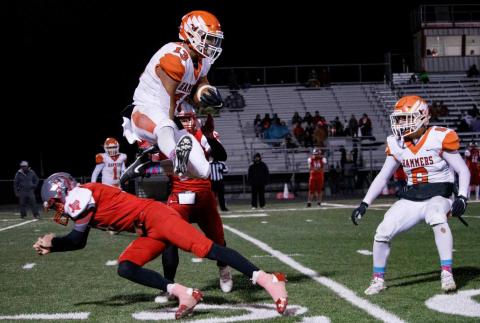 Sophomore Jaxon Warren hurdles Hermleigh defender while fielding a kick-off. (Photo by Mark Martinez)