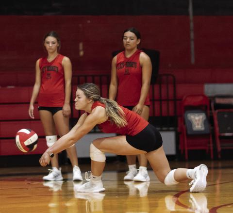 Senior Shelby Martin goes low for a dig during a morning practice session. PHOTO BY MARK MARTINEZ