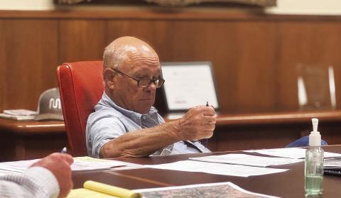 Stonewall County Commissioner Gary Myers reviews budget considerations during a budget workshop held when the court met in late June. PHOTO BY MARK MARTINEZ