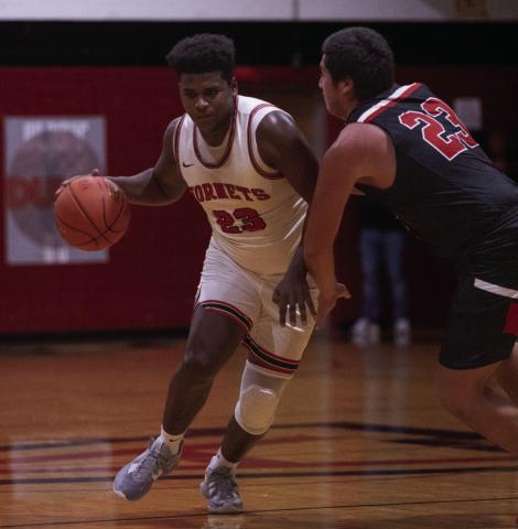 Aspermont senior Donovan Miller dribbles through a Tiger defender during the Hornets 55-38 win over Anson Tuesday night. (Photo by Mark Martinez)