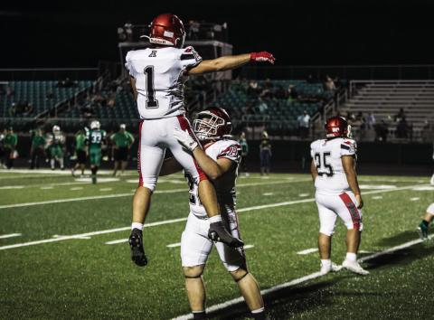Senior Mason Brannan (right) lifts teammate Kolby Bradshaw (Left) in celebration after a touchdown during last Friday's week 1 win over Blackwell. PHOTO BY: MARK MARTINEZ