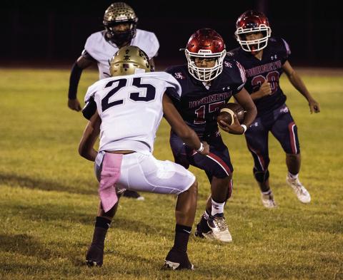 Aspermont Senior, Calob Castaneda, stars down a Jayton Jaybird defender as he carries the ball downfield towards the end zone