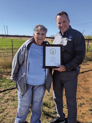 Justin Weaver, presented the award to Margie while visiting her homestead on a Tuesday morning (November 19, 2024).