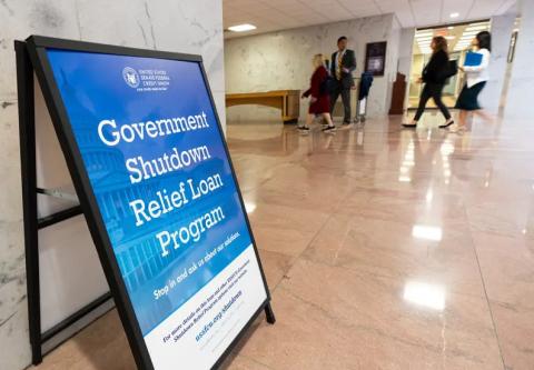 A sign advertises a government shutdown relief loan program outside the United States Senate Federal Credit Union branch office in the Hart Senate Office Building in Washington on Tuesday, Sept. 30, 2025. Credit: Bill Clark/CQ-Roll Call/Sipa USA via REUTERS