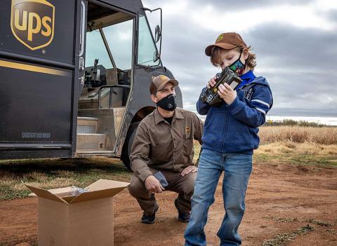 Conrad inspects the die-cast version of his new UPS truck, part of a special delivery received from James Klozinski, aka The Present Guy.
