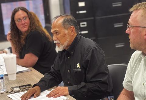 Gallagher Construction representative Nathan Umanos reviews the bid package and project “total sheet” with Rotan ISD trustees during the February board meeting as Rotan ISD Principal Jody Helms and WRA Architect Alex Fedrick listen in.