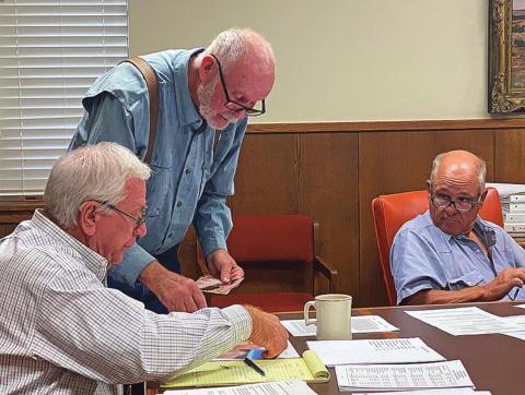 Stonewall County resident, Flynn Simmons points out areas of erosion along CR 410 with County Judge Ronnie Moorhead as Commission Gary Myers looks on.