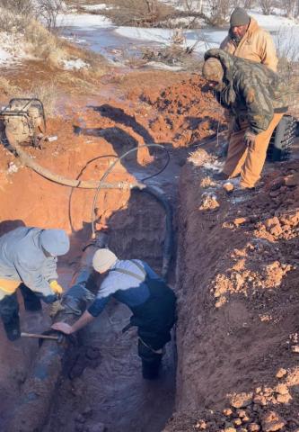 Aspermont City workers and citizen volunteers work tirelessly in icy water and arctic temperatures to repair the city's water supply. (Photo Curtesy of Brandon English)