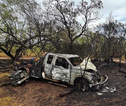 The charred remains of a pickup truck lie off Hwy 180, surrounded by scorched vegetation. Last week, the driver, Kyler Covington, was involved in a high-speed chase and gunfire incident after a motorist accidentally struck his dog. PHOTO BY JEFF HURT