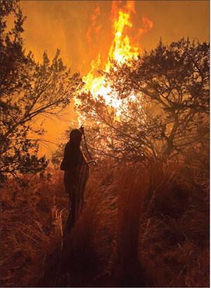 Stonewall County Judge Ronnie Moorhead battled off flames that threatened his house during last year's fire. PHOTO BY STEVEN ELLIS