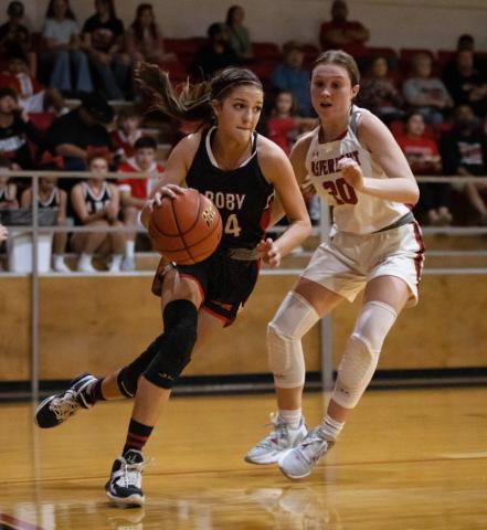 Lady Lion Hailee Garmer works to get around Aspermont's Kelly Lowack during the Roby's 36-24 win over Aspermont. (PHOTOS BY MARK MARTINEZ)