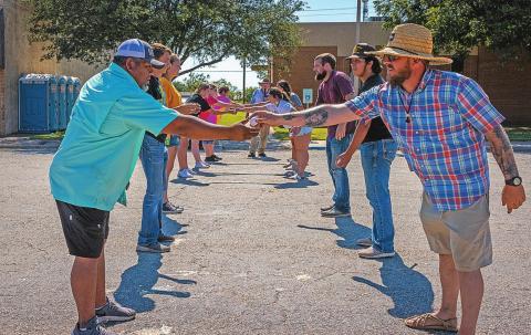 Aspermont's City Administrator Lorenzo Calamaco (left) receives the egg hand off from Mayor Steven Ellis (right) during the Egg Toss finals.
