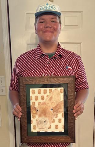James Bell holds his award-winning mixed media painting, Tater Tot, which was selected as the Congressional Art Competition winner for Texas’ 19th District.