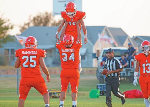 Rotan's Payton Carrillo lifts up teammate Grayson Jeffrey after scoring a touchdown. Photo by: Mark Martinez
