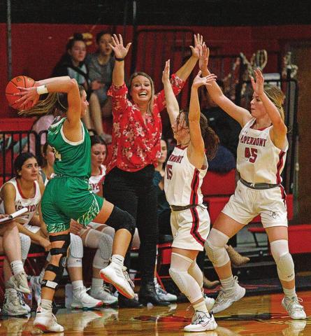 Lady Hornets Amilia Hecht &amp; Shelby Martin under direction of coach Tiffany Potts throw their hands up to defend against the Lady Piper offense. Photo by: Mark Martinez