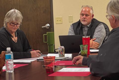 Stonewall Hospital District CEO Michael Moorhead and board president Ellen Abernathy listen in as district CFO Lewis Robbins (not pictured) delivers current financial reports as the district works to expand services.