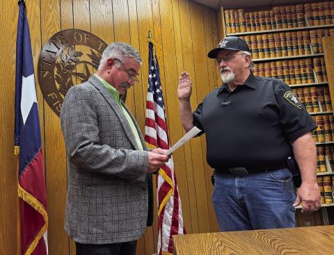 Fisher County Judge Ken Holt administers the oath of office to newly appointed Sheriff John Dickson on Monday, January 6.