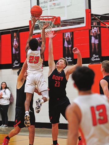 Jordan Daniel takes a high shot over two Lion defenders during the Hammers 53-38 win over Roby. Photo by: Tricia Hurt