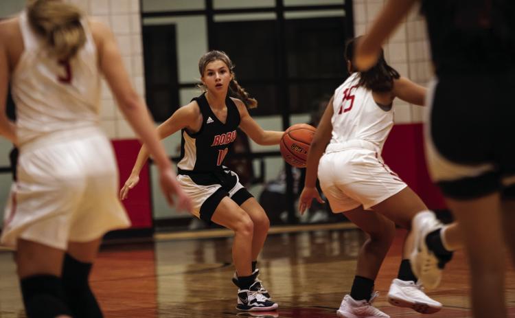 Roby sophomore Lilly Benson looks for an open teammate during Lady Lion's 23-41 loss to Anson on Tuesday night.