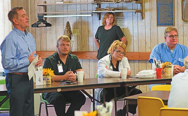 Stonewall Memorial Hospital District CEO Kyle Lee and Dr. Frederic Passmann introduce newly hired medical staff, Dr. Gwen Gorman and NP Kobie Benham while sharing lunch with community members last week at the Stonewall Senior Citizens Center.