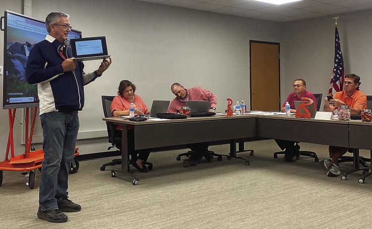Rotan ISD Technology Director Randy Hodges gives trustees some hands-on instruction for the new computers the district issued district trustees on Monday, allowing board members to keep in contact with school officials even in remote locations.