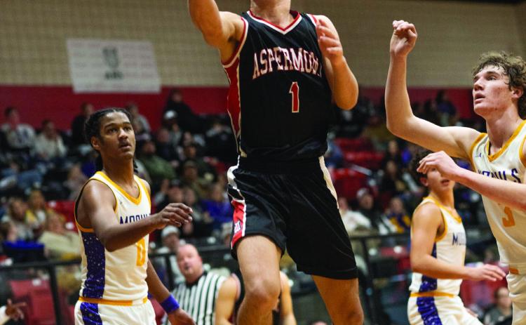 Aspermont junior Caleb Broshears cuts through the Munday defense for a layup during the Hornets 48-77 loss to the Moguls Tuesday night in the Bi-District round. The Hornets were able to keep pace with the Moguls through the first quarter before the Munday offense began pick things up and pull further away as the match progressed. The Hornets ultimately finish the season with a (16-14) record and 3rd place in District. Photo by: Mark Martinez