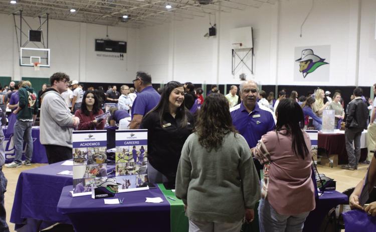 Western Texas College recruiters Isrell Lawson and Raúl Alcalá speak with prospective students at the 2024 College Fair.
