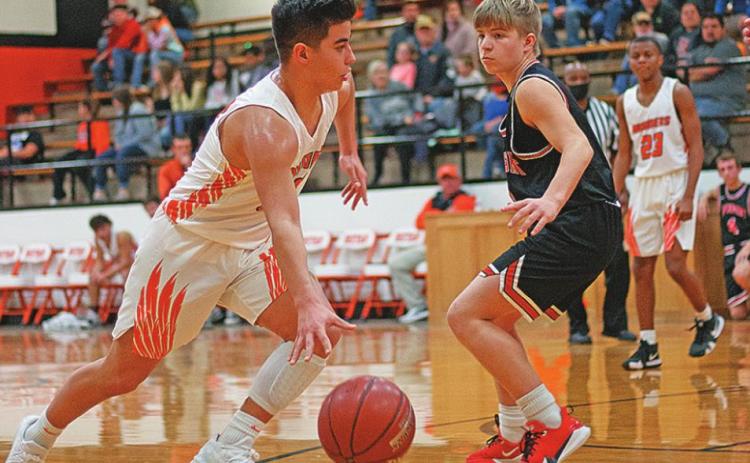 Rotan Yellowhammer Sophomore, Jaxon Warren drives around Aspermont Sophomore Keltyn Van Meter, towards the basket.