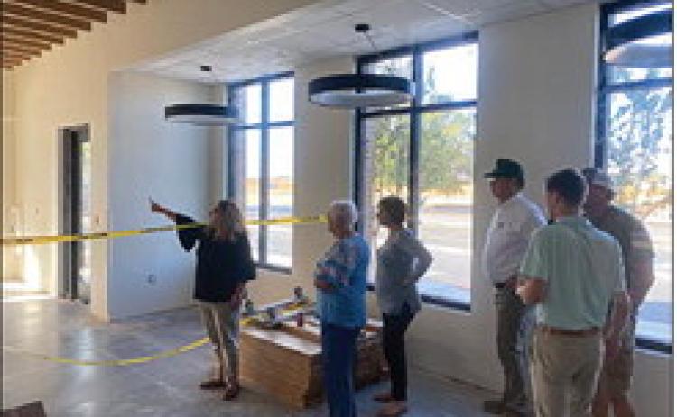 Fisher County Hospital CEO Leanne Martinez takes board members on a tour of the district’s new clinic and pharmacy as contractors work to complete the project in time for the grand opening something around October 1.